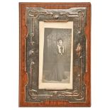 An English Art Nouveau oxidised copper photograph frame, c1910, backed on oak, 29 x 20cm Old