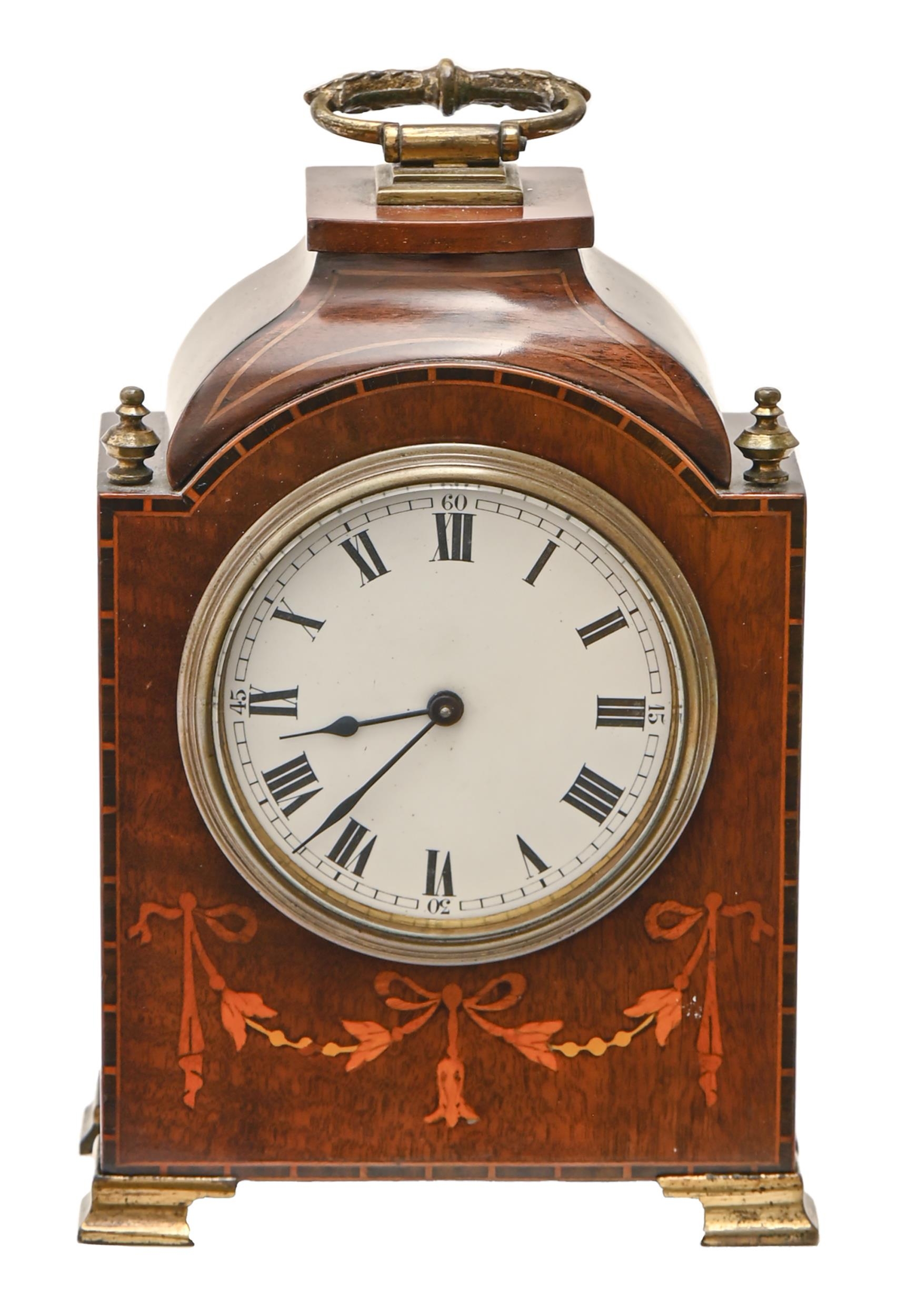 A mahogany and inlaid mantel timepiece, early 20th c, with brass handle, finials and ogee feet,