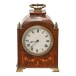 A mahogany and inlaid mantel timepiece, early 20th c, with brass handle, finials and ogee feet,