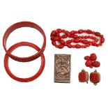 Two Chinese cinnabar lacquer bangles and a pair of ear clips mounted in white metal, early 20th c, a