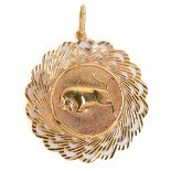 A pierced gold leaping bull pendant, 38mm diam, marked 750, 4.4g Slight wear
