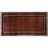 A red ground rug, 20th c, 102 x 196cm Slight wear