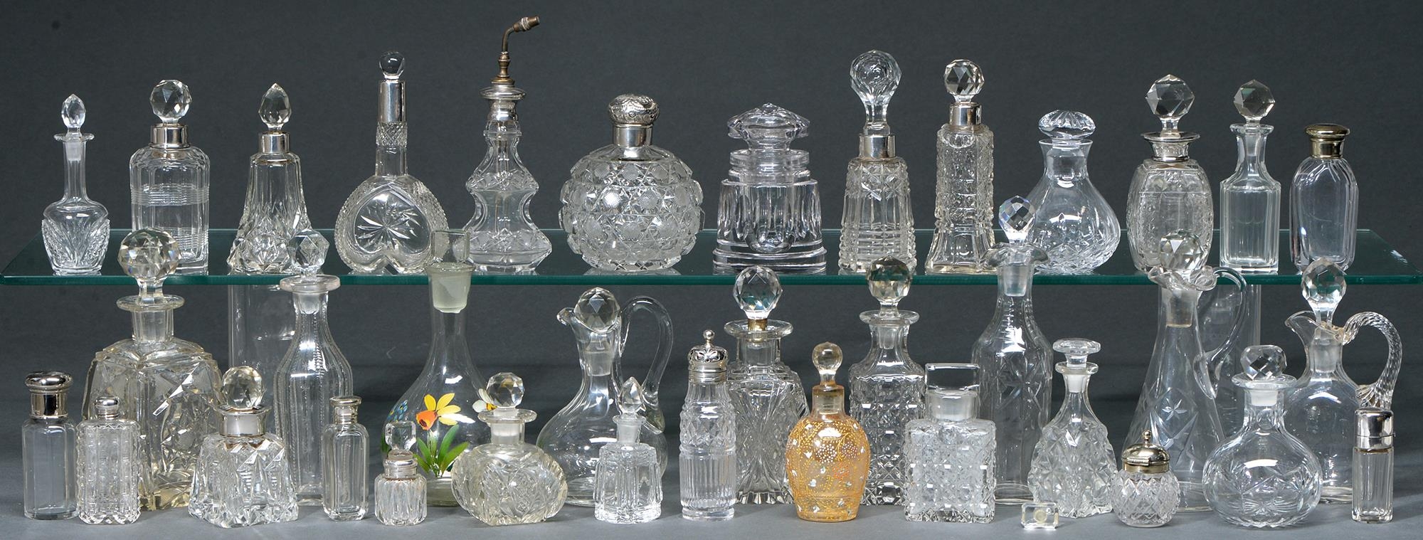 A collection of silver mounted and other cut glass scent bottles, late 19th - early 20th c,