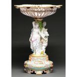 A Minton style porcelain triple figural fruit stand, c1870, the pale blue cavetto base with three