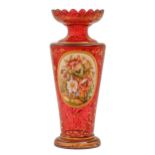 A Bohemian overlaid glass vase, c1870, of pan topped flared cylindrical shape in cranberry