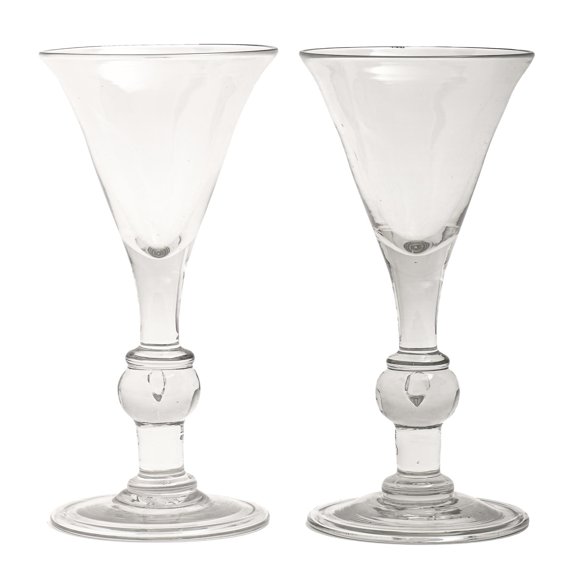 A pair of Victorian glass goblets, the trumpet bowl on solid stem with teared and bladed knops,