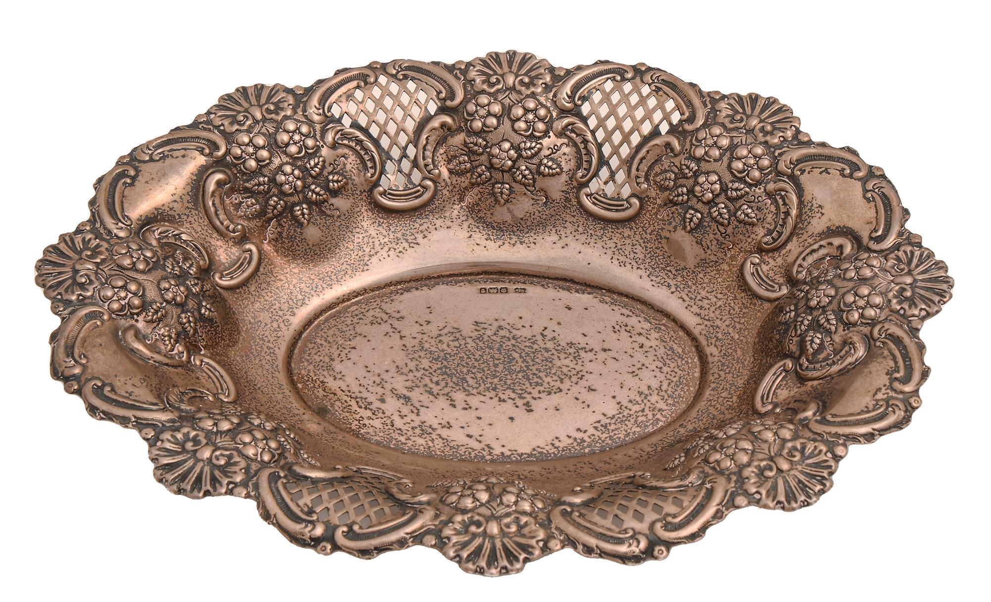 A George V silver fruit dish, die stamped with flowers and blind and open trellis, 31cm l, by Mappin