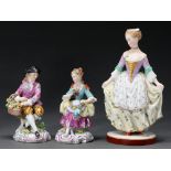 A pair of German porcelain figures of a seated youth and girl, 20th c, after Meissen models, 14cm h,