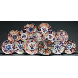 Thirteen Japanese Imari dishes, c1900, mostly fluted in scalloped rim, 23cm diam and circa Mostly in