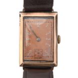 A 9ct gold rectangular gentleman's wristwatch, with bronzed dial and tonneau shaped movement, 22 x