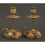 A pair of brass mounted Doulton Ware hand candlesticks, early 20th c, with floral sconce, drip pan