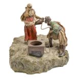 A cold painted Vienna bronze orientalist group of two figures at a well, Bergman Foundry, c1900,