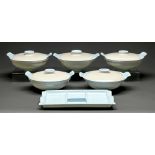 A set of five mid-century Poole pottery two tone blue and beige casserole dishes and covers and a