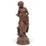 A French bronze statuette of a gleaner with a bird's nest, cast from a model by Mathurin Moreau (