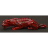 A Royal Doulton flambe model of a tiger, c1930, 23cm l, printed mark One or two tiny glaze chips