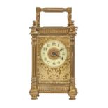 A French brass carriage timepiece, c1900, with primrose enamel chapter ring and pierced gilt brass