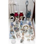 A collection of twenty-one Lladro figures, animals and a clock, late 20th / 21st c, lamplighter 47cm