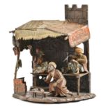 A cold painted Vienna bronze orientalist lamp, early 20th c, in the form of a stall with three