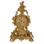 A French ormolu rococo revival mantel clock, mid 19th c, in Louis XV style, with enamel chapters,