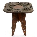 A Chinese carved wood ornamental dragon table, early 20th century, decorated with shou characters,
