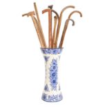 Miscellaneous sticks and canes, in a blue and white stand Condition evident from image