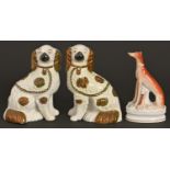 A Staffordshire earthenware model of a greyhound, 19th c, 21.5cm h and a pair of Staffordshire