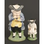 A Staffordshire earthenware snuff taker Toby jug, mid-19th c, sponged in polychrome, 28cm h,