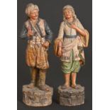 A pair of Austrian cold painted terracotta figures of a youth and girl, c1880, on rustic base,