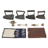 Four Victorian flat irons, a miniature silver trophy cup, etc
