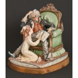 A Capo di Monte group of a young girl reading to her grandfather, affixed wood base, 36cm h Good