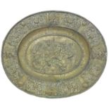 A Continental sheet brass dish, late 19th c, in 17th c style, embossed to the centre with lion