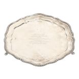 A George V silver salver, with gadrooned rim on three claw and ball feet, 26.5cm diam, by Walker &