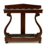 A Victorian mahogany umbrella stand, the top with shaped divisions on carved S-shaped supports and
