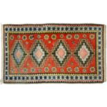 A medallion rug, 20th c, in polychrome, 220 x 125cm Good condition, light wear.