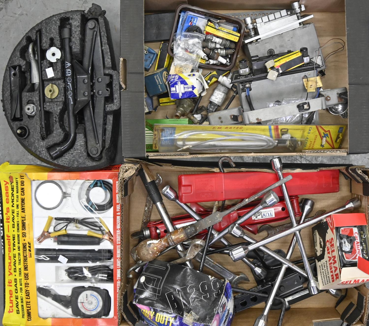 Miscellaneous tools and car parts, including stereos, wheel brace, Jaguar hub caps, etc