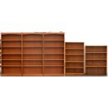 A set of three teak stained open bookcases, 1970's, with adjustable shelves, 180cm h; 28 x 89cm