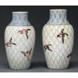 A pair of Japanese satsuma vases, decorated in the manner of contemporary Longwy Pottery, with birds