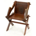 A Victorian carved oak 'Glastonbury' chair, of typically substantial pegged construction, the