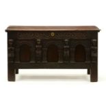 An oak chest, 17th c and later, the carved arcaded front with demi-figure appliques, on stiles,
