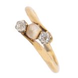 A diamond and pearl crossover ring, in gold, 3g, size K Light wear, solder sizing bead