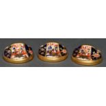 A set of three Royal Crown Derby Witches pattern place or menu stands, c1930, 33mm diam, printed