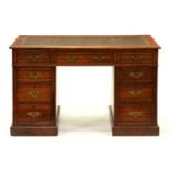 An Edwardian oak pedestal desk, 75cm h; 67 x 122cm The later green leather insert scratched and