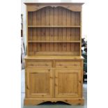 A waxed pine dresser, with boarded rack, 196cm h; 55 x 115cm Good condition