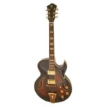 A jazz archtop guitar, dark brunette finish, highly ornamented, in abalone hard shell case