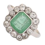 An emerald and diamond cluster ring,  the step cut emerald 7 x 8mm, in white gold, 3.5g, size O