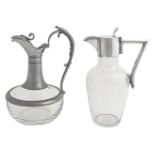 An EPNS mounted glass claret jug, early 20th c, 25cm h and a pewter mounted glass claret jug (2)