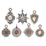 Seven silver prize watch fob shields, c1900-early 20th c, one enamelled with ace of clubs playing