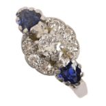 A sapphire and diamond ring, the central cluster flanked by heart shaped sapphires, gold hoop marked