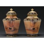 A pair of Noritake vases and covers, c1930, painted with continuous desert scenes, 18cm h, printed