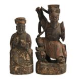 Two Chinese polychrome wood sculptures of immortals, 19th c, 29 and 36cm h Much dirt and some